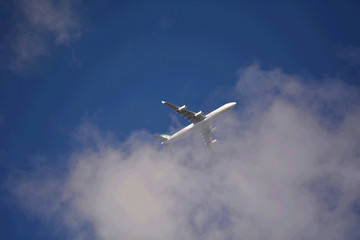 Airplane in the sky - cloudy but sunny day