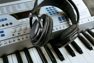 Headphones on synthesizer close up