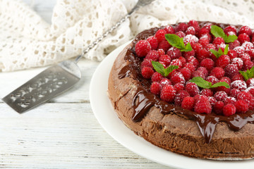 Cake with Chocolate Glaze and raspberries on color wooden background