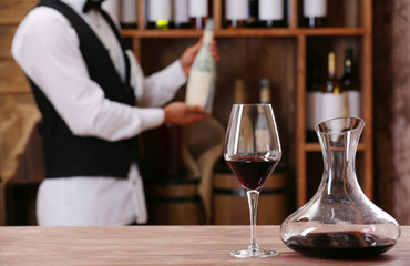 Bartender working at counter on bar background