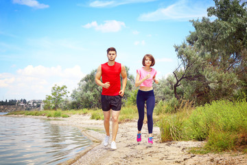 Young people jogging on beach