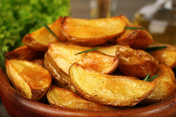 Baked potato wedges on table, closeup