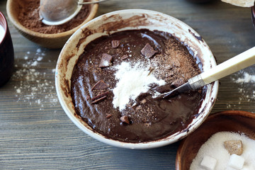 Preparing dough for chocolate pie on table close up