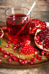 Fresh garnet juice with fruit on table close up