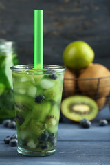 Kiwi and Blueberry cocktail on color wooden background