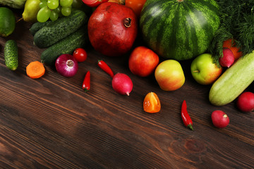 Heap of fruits and vegetables on wooden background
