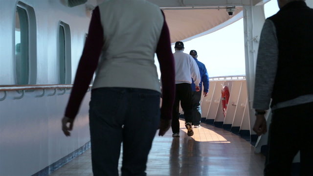 Passenger and crew walk cruise ship deck for exercise HD 7828