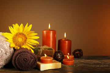 Beautiful spa composition with sunflowers on brown background