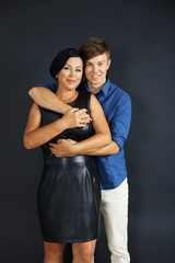 Portrait of mother and her son on dark background