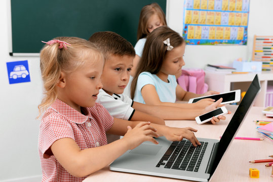 Group of children at laptop in the classroom
