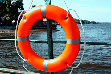 A life buoy hangs on the pier's handrail