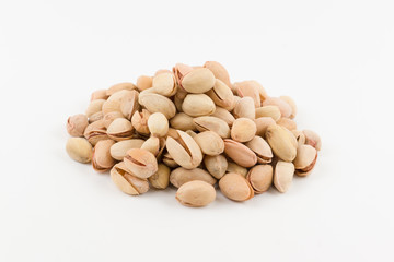 hill of pistachios in a shell lies on a white background