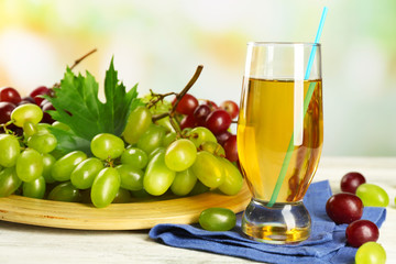 Glass with grape juice on blue napkin
