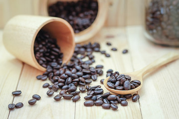 coffee bean and egg on the wood floor , selection focus point coffee bean on wooden spoon