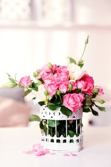 Fototapeta na wymiar Beautiful rose in vase on table in room on bright background