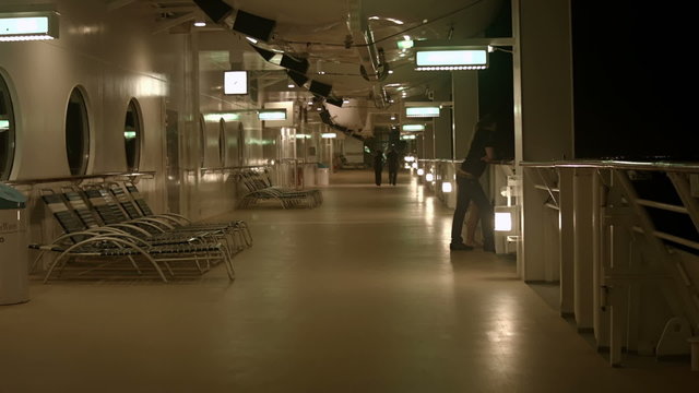Cruise ship night couples walking open deck HD BM 1936