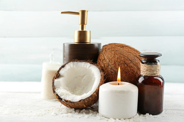 Spa coconut products on light wooden background