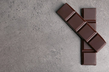Dark chocolate pieces on  dark gray background