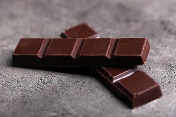 Dark chocolate pieces on  dark gray background