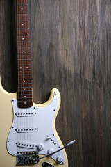Fototapeta premium Electric guitar on wooden background, close up
