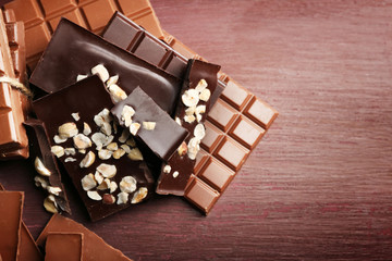 Variety of chocolate pieces on wooden background