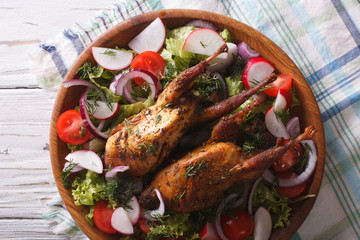 fried quail and fresh vegetables close-up. horizontal top view
