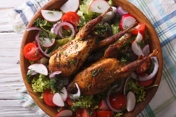 roasted quail and fresh vegetables close-up. horizontal top view
