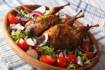 baked whole quail and fresh vegetables close-up. Horizontal
