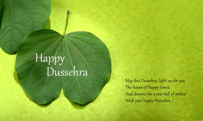 Indian Festival Dussehra, showing golden leaf on green background. Greeting card.