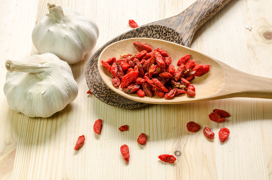 Dried goji berries on wooden tablespoon
