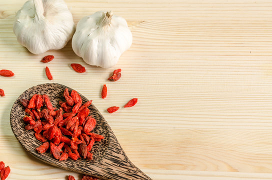 Dried goji berries on wooden tablespoon