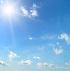 Naklejka na ściany i meble sun on blue sky with white clouds