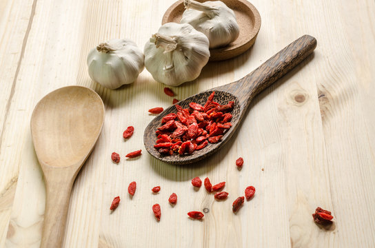 Dried goji berries on wooden tablespoon