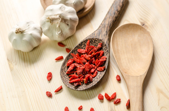 Dried goji berries on wooden tablespoon