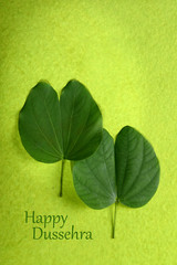 Indian Festival Dussehra, showing golden leaf on green background. Greeting card.