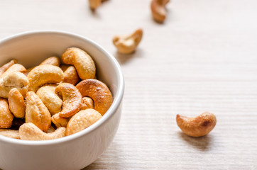 Fototapeta premium Close up cashew nuts on wooden background