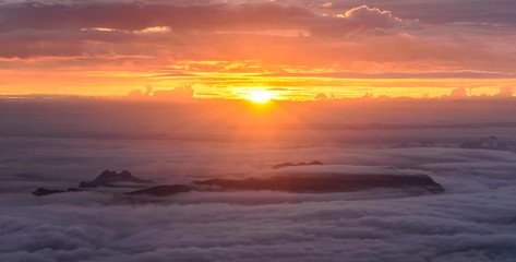 Fototapeta premium Panoramic view of morning mist with mountain at sunrise in Phu Kradueng national park, Loei Thailand.