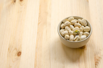 Pistachios Nuts on wooden background