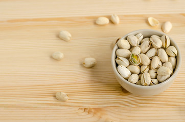 Pistachios Nuts on wooden background