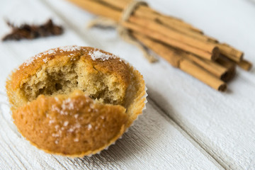 Cupcake with cinnamon on wood