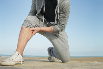 jogging man suffering from cramp muscle pain holding painful muscle