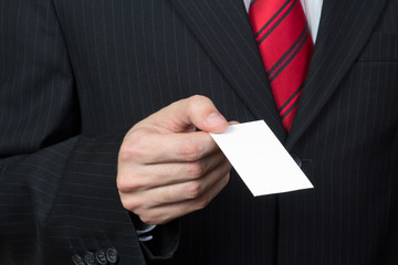 Unrecognizable businessman holding a card in hand