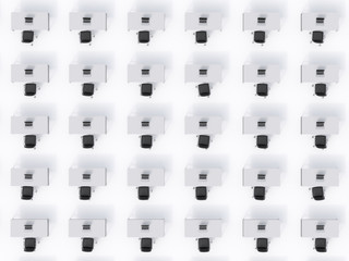 A top view of the symmetric corporate workplaces on white floor. A concept of corporate life in a huge transnational company. Black leather chairs, white tables and modern laptops. 3D rendering.