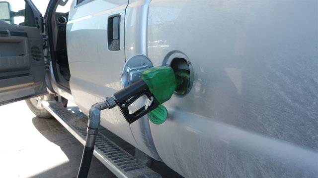 Man filling pickup truck with diesel gas fuel HD 3526