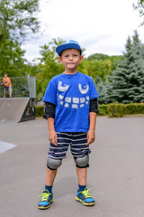Cute young boy in his skateboarding outfit