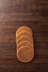 Waffles with caramel on wood