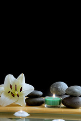 Still life with spa stones on black background