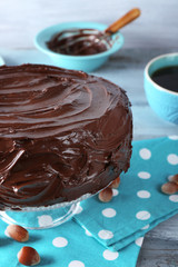 chocolate cake with hazelnuts and coffee on table