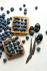 Naklejka na ściany i meble Gourmet fresh blueberry tarts on table