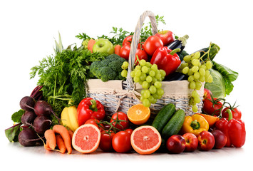 Fototapeta na wymiar Organic vegetables and fruits in wicker basket isolated on white